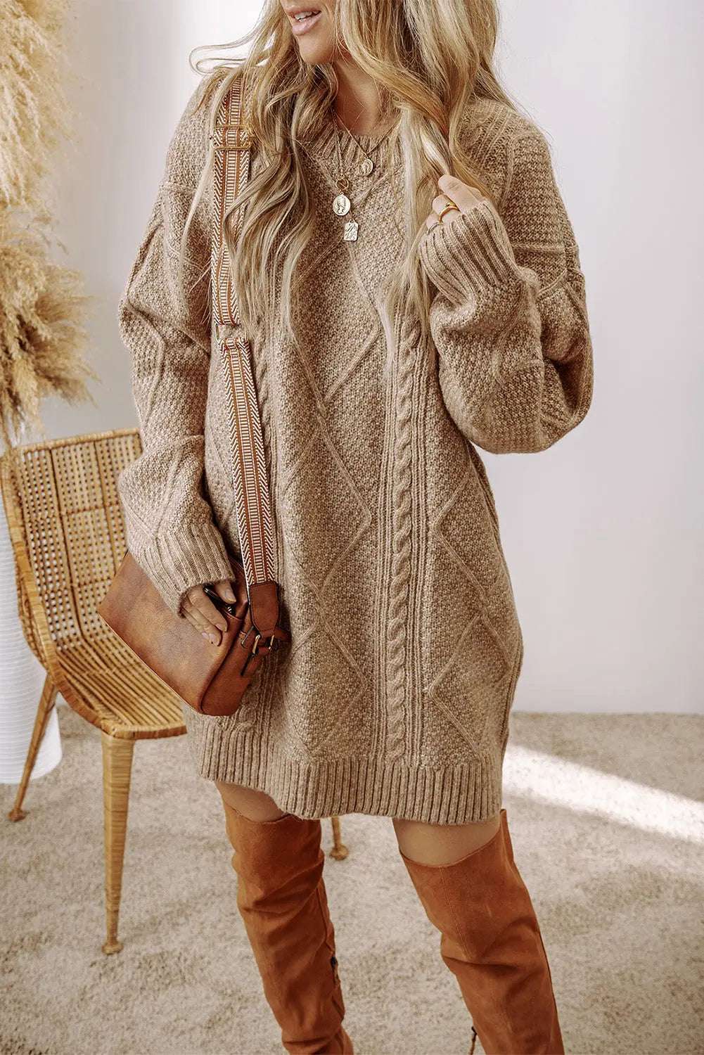 Knitted cable knit sweater dress with a loose fit 