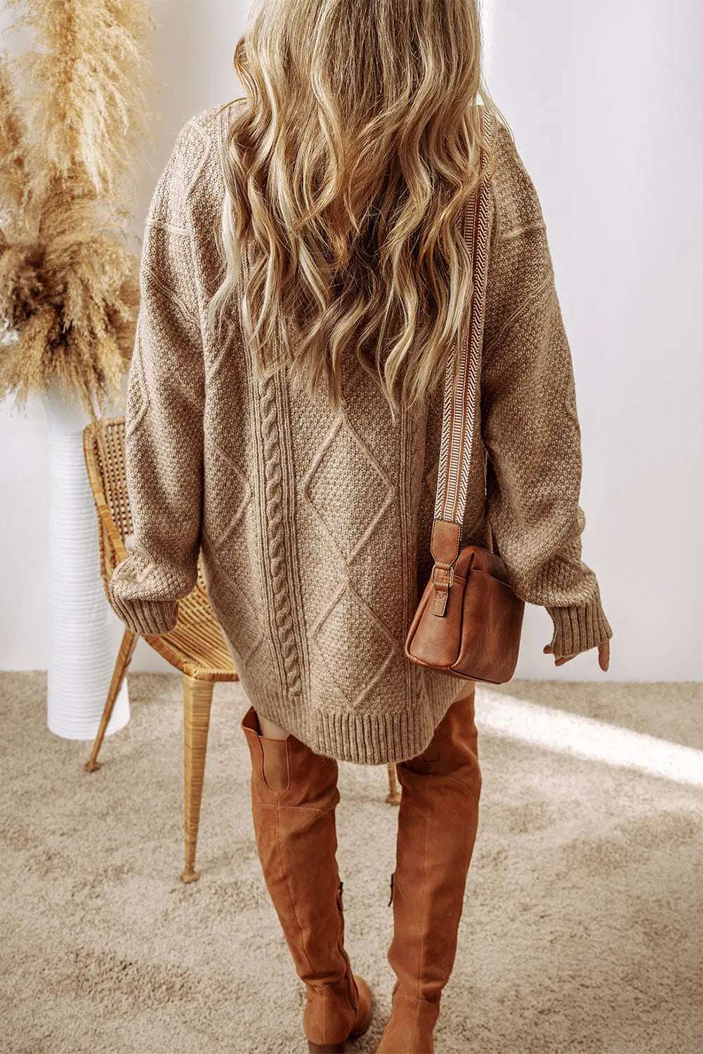 Knitted cable knit sweater dress with a loose fit 