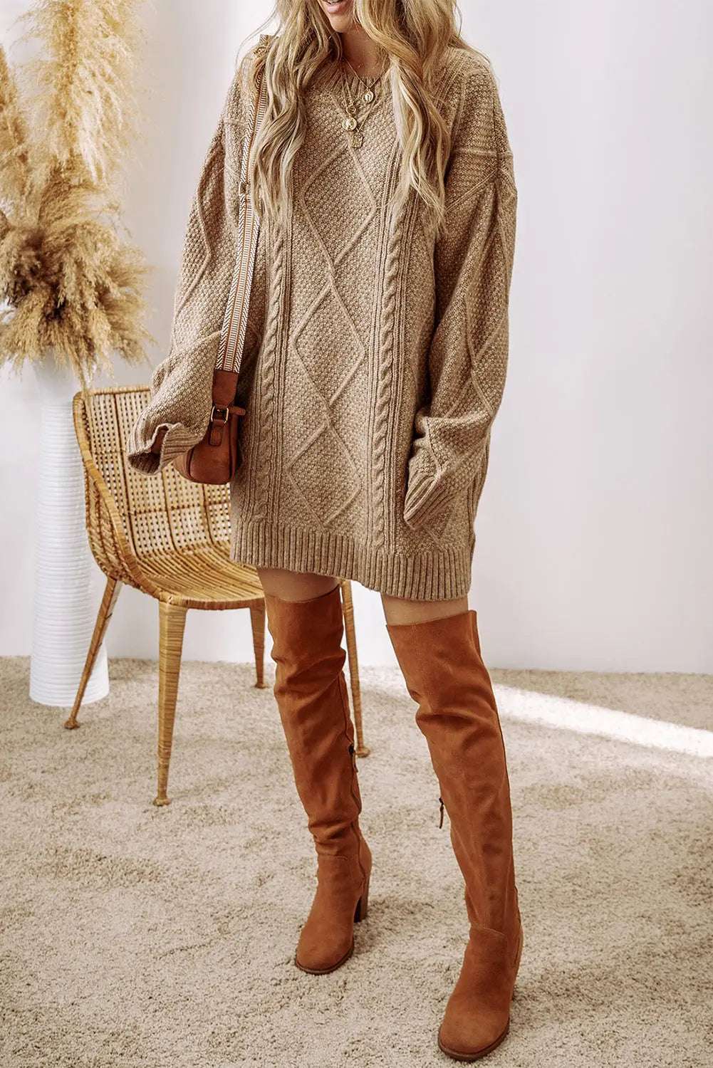 Knitted cable knit sweater dress with a loose fit 